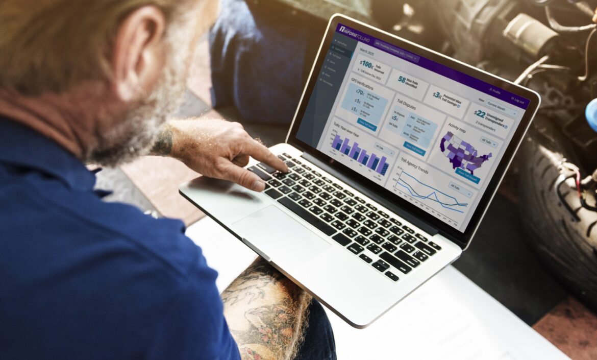 ai toll management - man holding a laptop looking at a tolling analytics dashboard